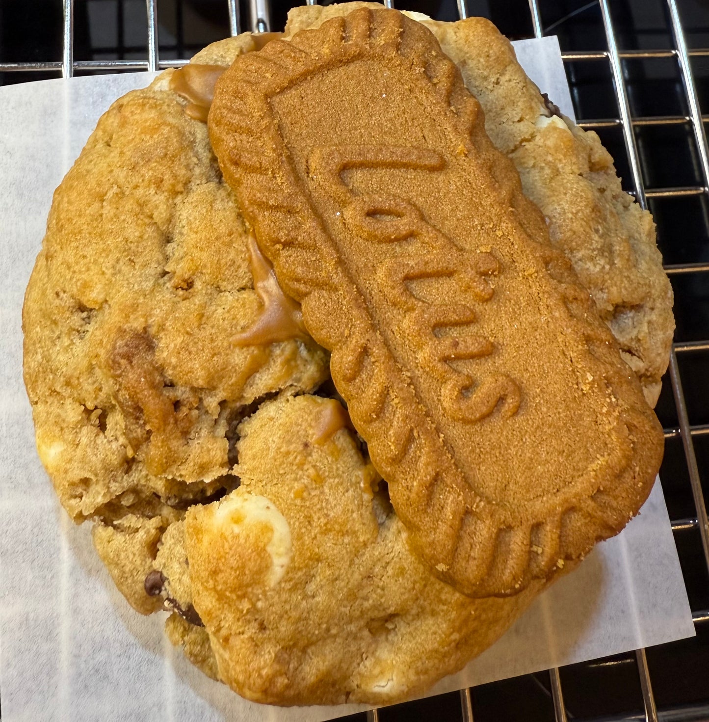 A Biscoff cookie with white chocolate chips and a visible Lotus biscoff butter print on top